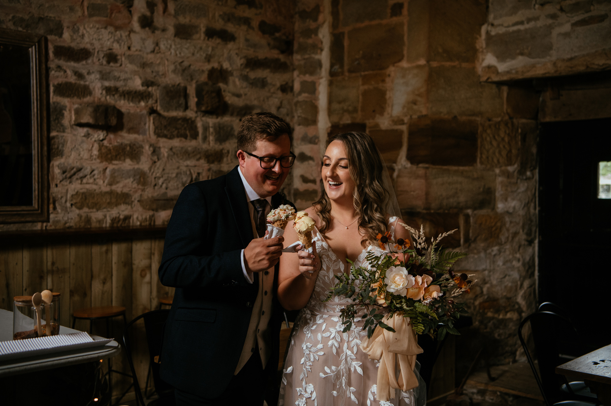 Bride and Groom holding ice creams at Danby Castle wedding