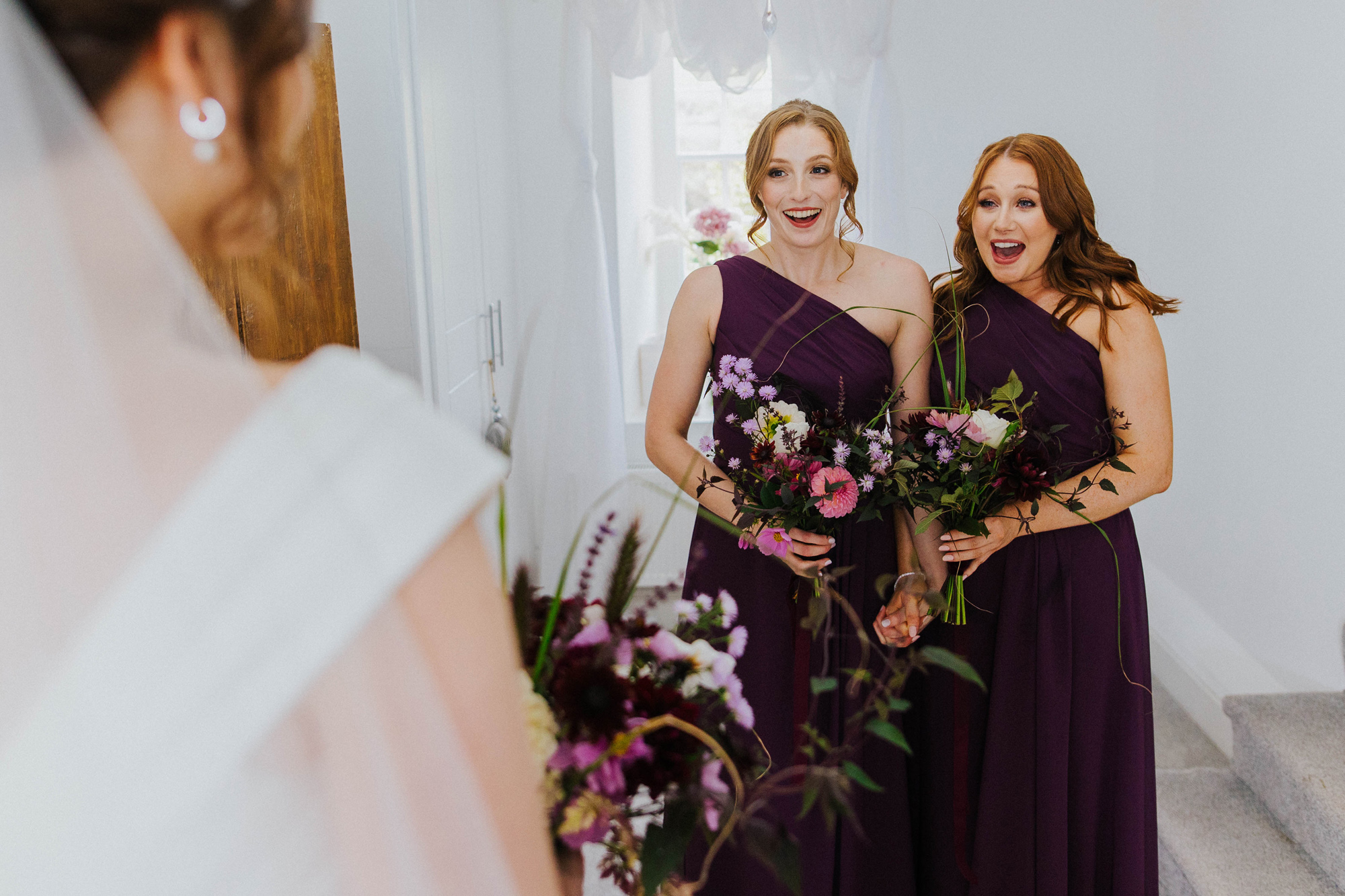 Bridesmaids in one purple one shoulder bridesmaids dresses. . Moonwind Flowers.