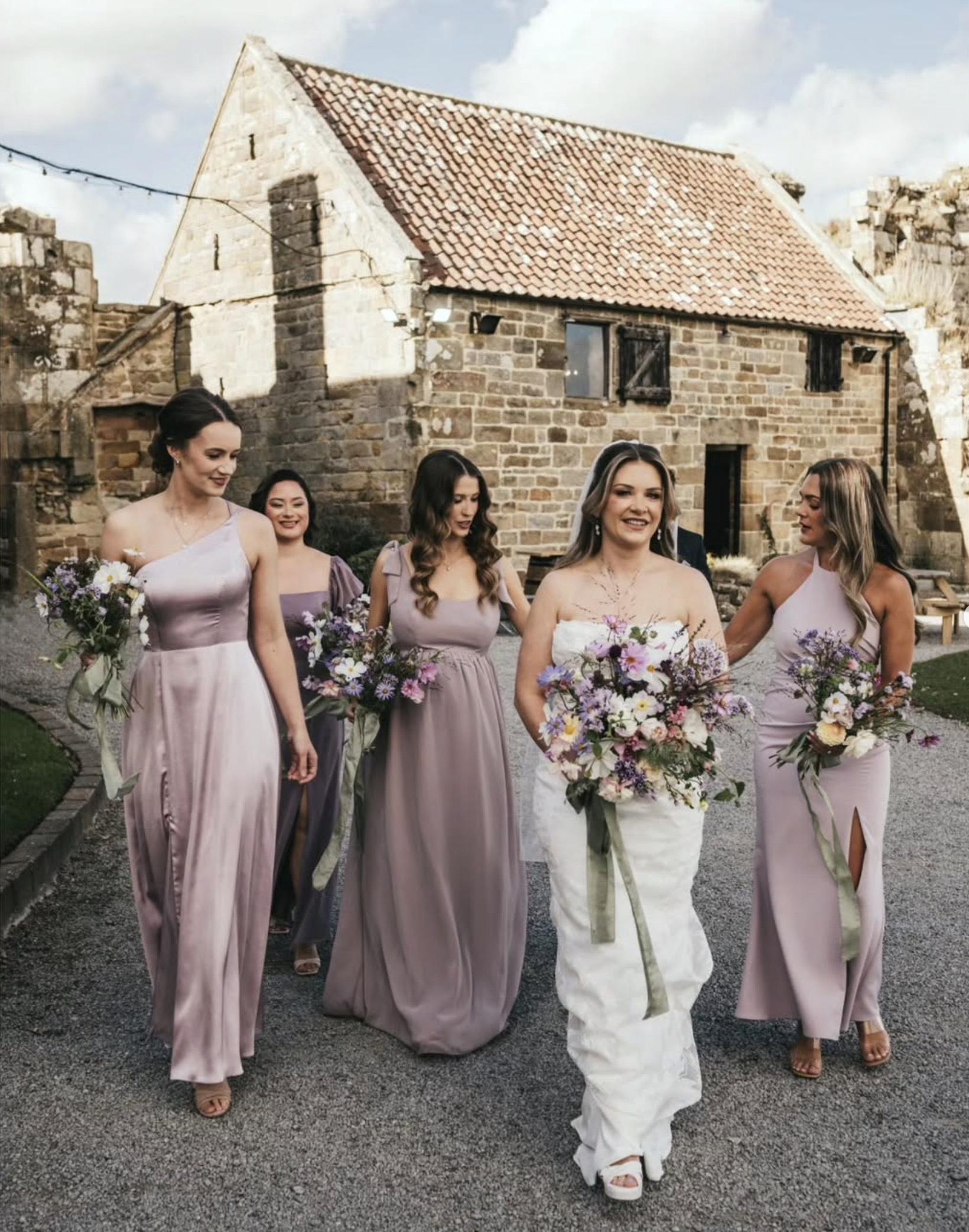 Bride carrying a lilac wedding bouquet, Moonwind Flowers, Danby Castle, Sam Chipman Photography